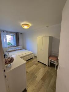 a bedroom with a bed and a cabinet and a table at Apartments Laura in Korčula