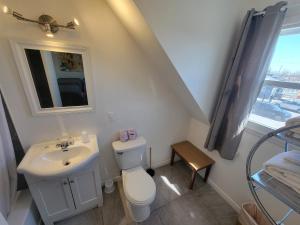 a bathroom with a white toilet and a sink at Motel Grande Ile in Salaberry-de-Valleyfield +79 photos