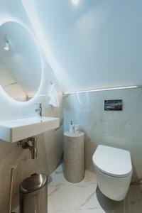 a white bathroom with a sink and a toilet at Gate67 in Otopeni +99 photos