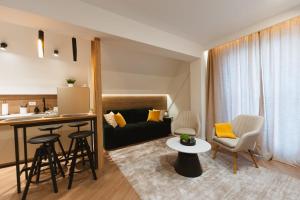 a kitchen and living room with a couch and a table at Gate67 in Otopeni