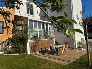 a patio with a table and chairs in front of a house at Gite La Forge in Rochecorbon