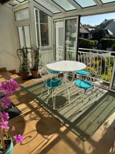 a patio with a table and chairs on a balcony at Gite La Forge in Rochecorbon +11 photos