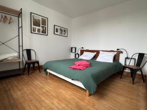 a bedroom with a bed with a red shirt on it at Gite La Forge in Rochecorbon