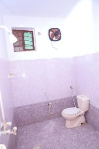 a bathroom with a toilet and a window at Sehrai Royal Villa in Multan