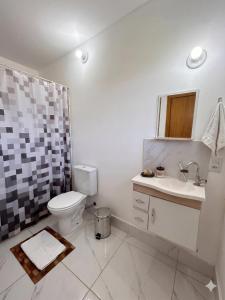 a bathroom with a toilet and a sink and a shower at Pousada Mais Cacau in Itu +14 photos