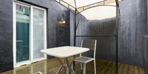 a white table and a chair in a room at 월호텔 in Pyeongtaek