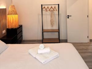 a bedroom with a bed with two towels on it at Apartmento 3037 in Quarteira