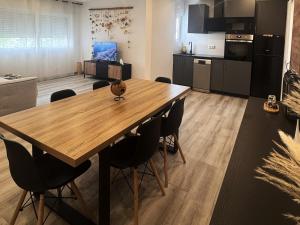 a kitchen and dining room with a wooden table and chairs at Apartmento 3037 in Quarteira