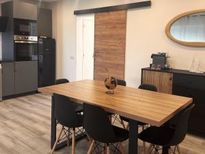 a wooden table in a kitchen with black chairs at Apartmento 3037 in Quarteira +19 photos