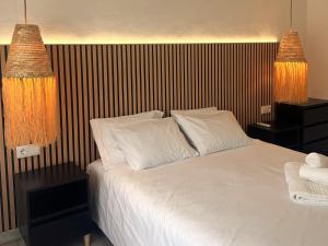 a bedroom with a white bed and two lamps at Apartmento 3037 in Quarteira