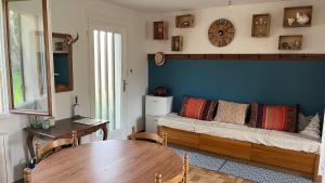 a living room with a couch and a table at L'Ombre du pommier in Paron