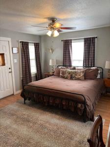 a bedroom with a bed and a ceiling fan at The Gates House in Brady