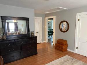 a living room with a dresser and a mirror at The Gates House in Brady
