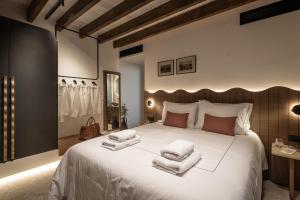 a bedroom with a large white bed with towels on it at Abas Villas in Paránimfoi