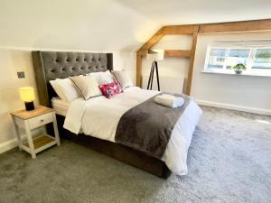 a bedroom with a large bed and a window at The Oaks in Blackburn