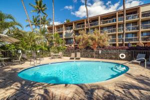 a swimming pool in front of a hotel at Top floor ocean view Maui Vista 3405 in Kihei
