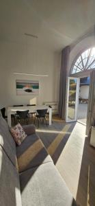 a living room with a couch and a table at Blue Living -Archi di Mare in Marciana Marina