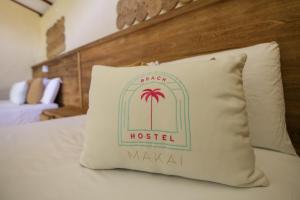 a pillow sitting on a bed in a hotel room at MAKAI BEACH HOSTEL in Punta de Piedra +42 photos