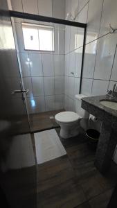 a bathroom with a toilet and a sink at Hotel Calema in Capitão Leônidas Marques