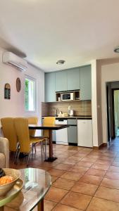 a kitchen and living room with a table and chairs at Apartments Ivanović in Kotor