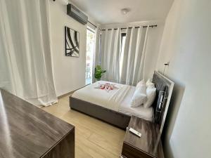 a bedroom with a bed with a television in it at Luxurious Orchid Apartment in Bijilo