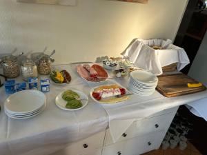 a table with plates and bowls of food on it at Seehaus Miersdorf in Zeuthen +23 photos