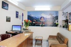 a waiting room at a hotel with a large poster on the wall at Hotel Kasturi in Gangtok