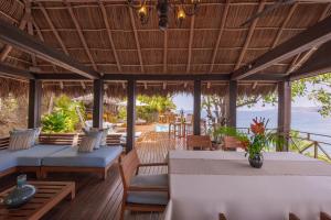 a restaurant with tables and chairs on a deck at Hotel Boutique Siete Lunas in Sayulita