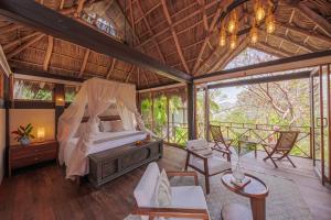 a bedroom with a bed in a tree house at Hotel Boutique Siete Lunas in Sayulita