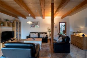 a living room with two couches and a tv at Schwedenstern - Familienurlaub an der Ostsee in Kochendorf