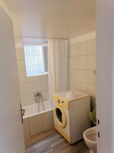 a bathroom with a washing machine and a toilet at comfortable room and shared kitchen and bathroom in Athens