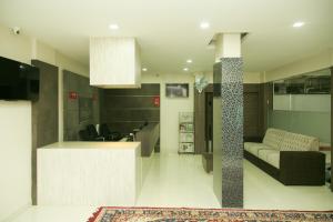 a living room with a couch and a table at Dream Land Residency in Mananthavady