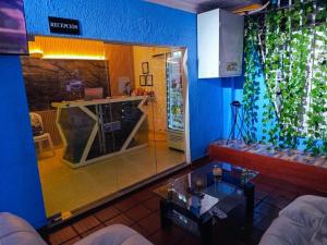 a living room with a counter and a glass wall at Hotel Casa Manzanares in Santa Marta