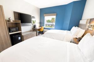 a hotel room with two beds and a flat screen tv at Holiday Inn Express St Augustine near Dtwn - Historic by IHG in St. Augustine +31 photos