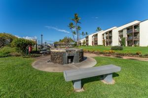 a bench in a park next to a building at Conveniently located two bedroom two bath HK319 in Wailea