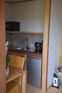 a kitchen with a sink and a dishwasher at Maison Zélandaise in Koudekerke +43 photos