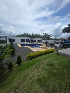 a large white building with a lawn in front of it at Finca Villa Sonada in Darién