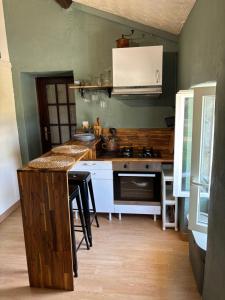 a kitchen with a counter and a stove top oven at La Grange aux coccinelles in Saint-Martin-des-Fontaines