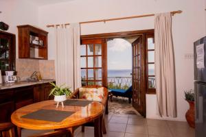 a kitchen with a table and a view of the ocean at Catcha Falling Star in Negril
