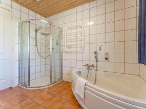 a bathroom with a tub and a glass shower at Chapter Two in Niedernsill +42 photos