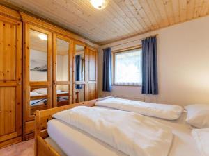 a bedroom with two beds and a window at Chapter Two in Niedernsill