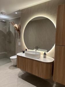 a bathroom with a sink and a toilet and a mirror at Strömstad/Stromstad close to the sea in Strömstad +14 photos