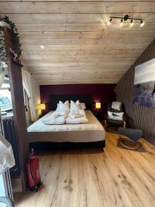 a bedroom with a bed with a wooden ceiling at Hoofprints Farm stay in Fludir