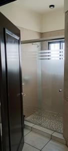a shower with a glass door in a bathroom at Casa Mojave in La Paz +28 photos