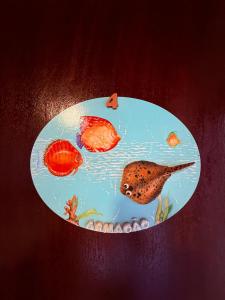 a plate with fish in the water on a table at Pousada bella mar buzios in Búzios