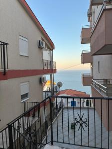 a balcony of a building with a view of the ocean at Agniya in Seoca +5 photos