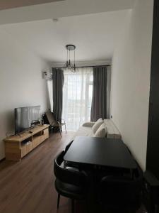 a bedroom with a bed and a tv in a room at TelaValley Residence in Shalauri