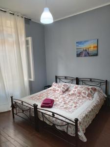 a bedroom with a bed with a blanket on it at comfortable room and shared kitchen and bathroom in Athens