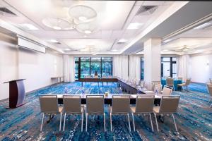 a conference room with a long table and chairs at EVEN Hotel Miami - Airport by IHG in Miami +147 photos