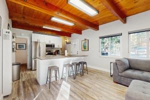a kitchen and living room with a bar and a couch at Speckled Tahoe in Kings Beach